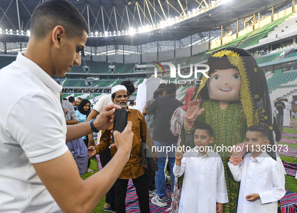 Children are celebrating after performing the Eid al-Adha morning prayer at the Education City Stadium on the first day of the Eid al-Adha h...