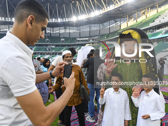 Children are celebrating after performing the Eid al-Adha morning prayer at the Education City Stadium on the first day of the Eid al-Adha h...