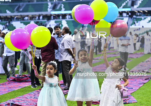 Children are celebrating after performing the Eid al-Adha morning prayer at the Education City Stadium on the first day of the Eid al-Adha h...