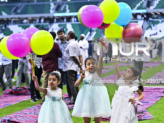 Children are celebrating after performing the Eid al-Adha morning prayer at the Education City Stadium on the first day of the Eid al-Adha h...