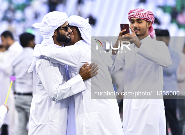 People are greeting each other after performing the Eid al-Adha morning prayer at the Education City Stadium on the first day of the Eid al-...