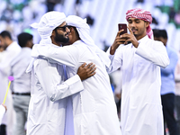 People are greeting each other after performing the Eid al-Adha morning prayer at the Education City Stadium on the first day of the Eid al-...