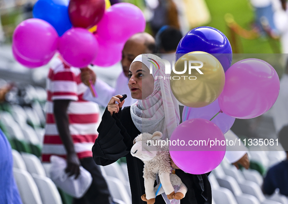 People are celebrating after performing the Eid al-Adha morning prayer at the Education City Stadium on the first day of the Eid al-Adha hol...