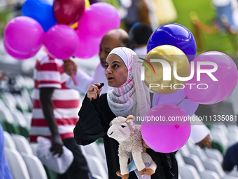 People are celebrating after performing the Eid al-Adha morning prayer at the Education City Stadium on the first day of the Eid al-Adha hol...