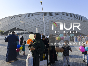 Worshipers are leaving the stadium after performing the Eid al-Adha morning prayer on the first day of the Eid al-Adha holiday in Doha, Qata...