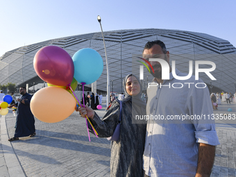 Worshipers are leaving the stadium after performing the Eid al-Adha morning prayer on the first day of the Eid al-Adha holiday in Doha, Qata...