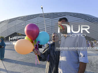 Worshipers are leaving the stadium after performing the Eid al-Adha morning prayer on the first day of the Eid al-Adha holiday in Doha, Qata...