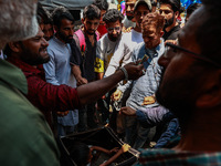 People are watching a magic show organized by non-Kashmiris from different states of India ahead of Eid-Ul-Adha in Sopore, Jammu and Kashmir...