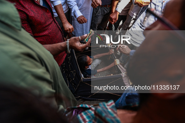 People are watching a magic show organized by non-Kashmiris from different states of India ahead of Eid-Ul-Adha in Sopore, Jammu and Kashmir...