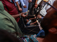 People are watching a magic show organized by non-Kashmiris from different states of India ahead of Eid-Ul-Adha in Sopore, Jammu and Kashmir...