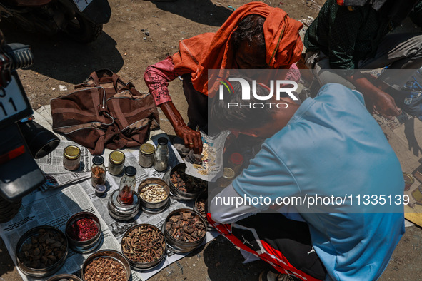 Non-locals are selling herbal medicines, which they claim have been collected from forests in Sopore, Jammu and Kashmir, India, on June 16,...