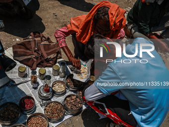 Non-locals are selling herbal medicines, which they claim have been collected from forests in Sopore, Jammu and Kashmir, India, on June 16,...