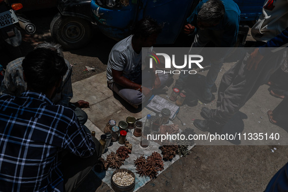 Non-locals are selling herbal medicines, which they claim have been collected from forests in Sopore, Jammu and Kashmir, India, on June 16,...