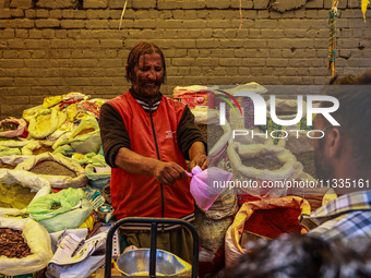 A vendor is selling spices to customers ahead of Eid-Ul-Acha in Sopore, Jammu and Kashmir, India, on June 16, 2024 (