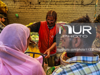 A vendor is selling spices to customers ahead of Eid-Ul-Acha in Sopore, Jammu and Kashmir, India, on June 16, 2024 (