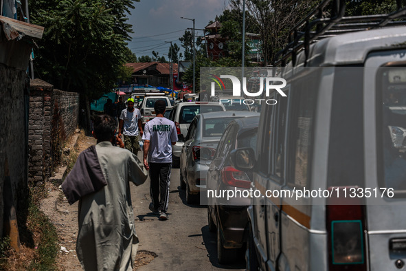 People are walking as they shop for Eid-Ul-Adha in Sopore, Jammu and Kashmir, India, on June 16, 2024. 