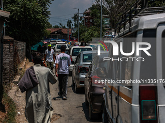 People are walking as they shop for Eid-Ul-Adha in Sopore, Jammu and Kashmir, India, on June 16, 2024. (