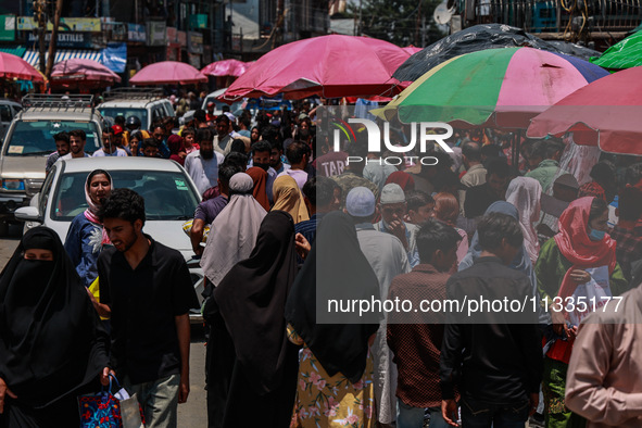 People are walking as they shop for Eid-Ul-Adha in Sopore, Jammu and Kashmir, India, on June 16, 2024. 