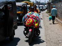 A biker is moving with garlands put on a bike in Sopore, Jammu and Kashmir, India, on June 16, 2024. (