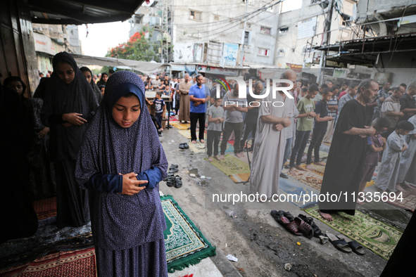 Palestinians are holding Eid al-Adha prayers in Bureij Refugee Camp in the central Gaza Strip, on June 16, 2024, amid the ongoing conflict b...