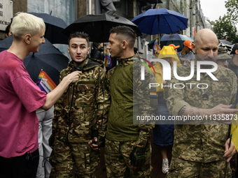 Ukrainian servicemen are taking part in the Equality March, organized by the LGBT+ community that is gathering for the first time since Russ...