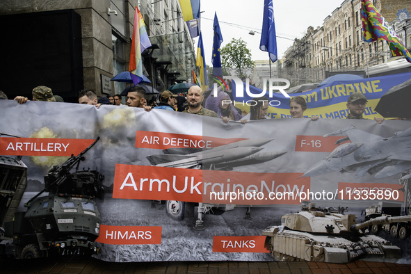 Participants are holding a banner, calling for air defense for Ukraine, at the Equality March, organized by the LGBT+ community that is gath...