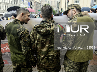 Ukrainian servicemen are taking part in the Equality March, organized by the LGBT+ community that is gathering for the first time since Russ...