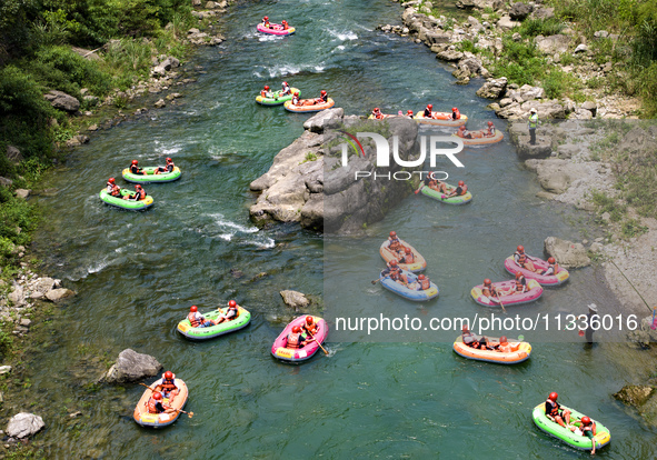 Tourists are experiencing canyon rafting cooling at Jiuwan River rafting scenic spot in Yichang, China, on June 15, 2024. Recently, many pla...