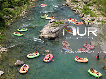 Tourists are experiencing canyon rafting cooling at Jiuwan River rafting scenic spot in Yichang, China, on June 15, 2024. Recently, many pla...