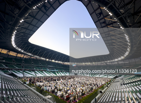 Worshipers are performing Eid al-Adha prayers at the Education City Stadium on the first day of the Eid al-Adha holiday in Doha, Qatar, on J...