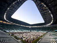 Worshipers are performing Eid al-Adha prayers at the Education City Stadium on the first day of the Eid al-Adha holiday in Doha, Qatar, on J...