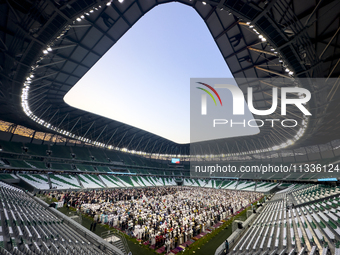 Worshipers are performing Eid al-Adha prayers at the Education City Stadium on the first day of the Eid al-Adha holiday in Doha, Qatar, on J...