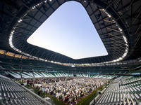 Worshipers are performing Eid al-Adha prayers at the Education City Stadium on the first day of the Eid al-Adha holiday in Doha, Qatar, on J...