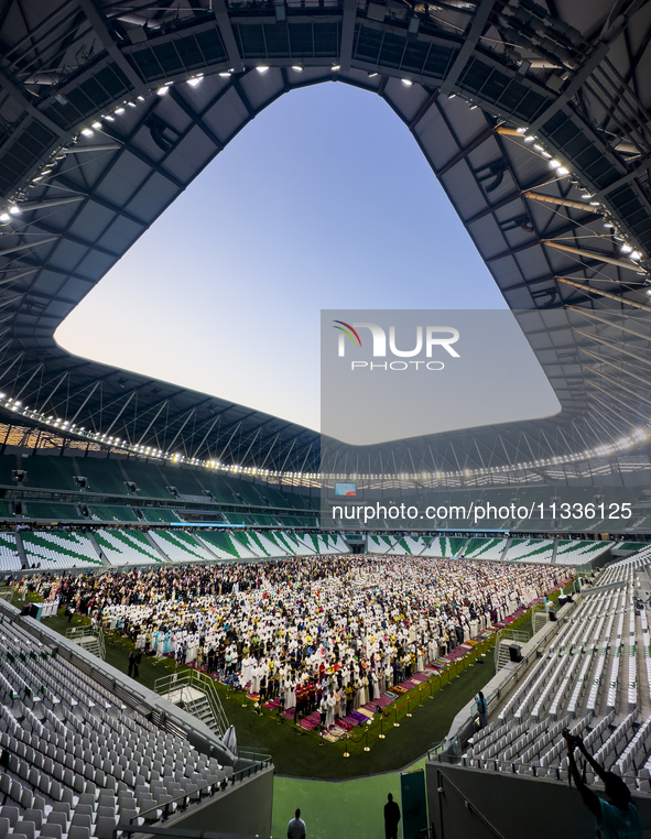 Worshipers are performing Eid al-Adha prayers at the Education City Stadium on the first day of the Eid al-Adha holiday in Doha, Qatar, on J...