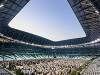 Worshipers are performing Eid al-Adha prayers at the Education City Stadium on the first day of the Eid al-Adha holiday in Doha, Qatar, on J...