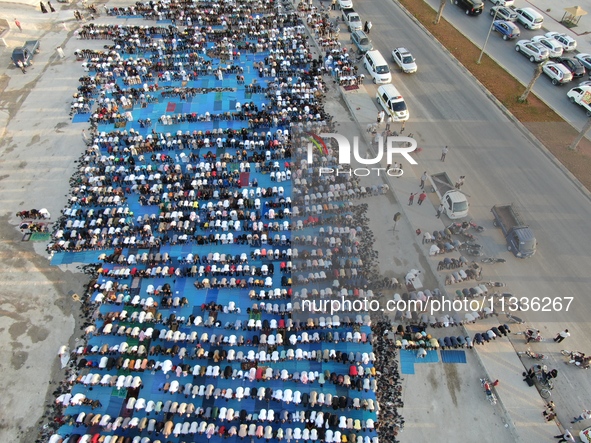 Muslims in Syria perform Eid al-Adha prayers in an open-air area in Bab al-Hawa Square, in the countryside of Idlib, northwest Syria, on the...