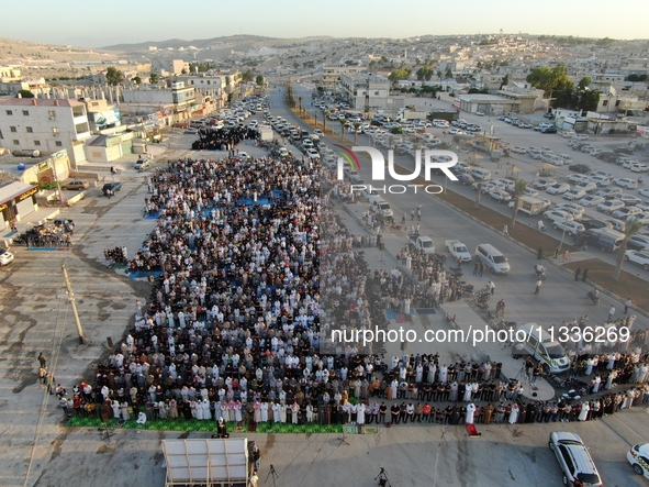 Muslims in Syria perform Eid al-Adha prayers in an open-air area in Bab al-Hawa Square, in the countryside of Idlib, northwest Syria, on the...