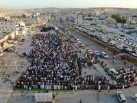 Muslims in Syria perform Eid al-Adha prayers in an open-air area in Bab al-Hawa Square, in the countryside of Idlib, northwest Syria, on the...