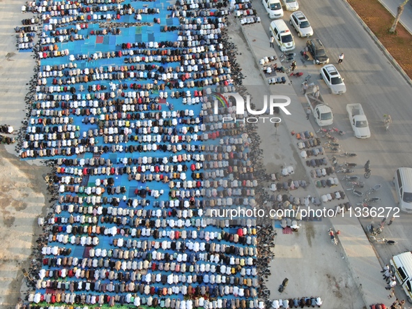 Muslims in Syria perform Eid al-Adha prayers in an open-air area in Bab al-Hawa Square, in the countryside of Idlib, northwest Syria, on the...