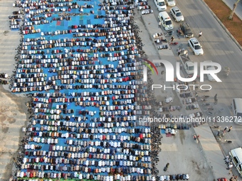 Muslims in Syria perform Eid al-Adha prayers in an open-air area in Bab al-Hawa Square, in the countryside of Idlib, northwest Syria, on the...