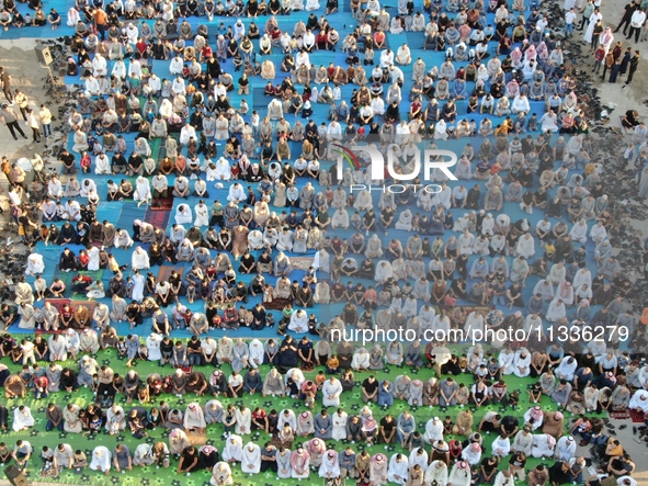 Muslims in Syria perform Eid al-Adha prayers in an open-air area in Bab al-Hawa Square, in the countryside of Idlib, northwest Syria, on the...