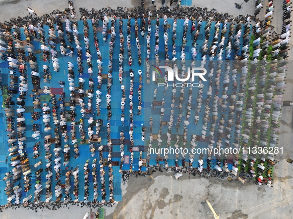 Muslims in Syria perform Eid al-Adha prayers in an open-air area in Bab al-Hawa Square, in the countryside of Idlib, northwest Syria, on the...