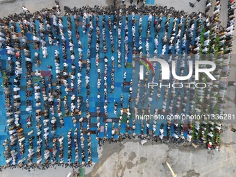 Muslims in Syria perform Eid al-Adha prayers in an open-air area in Bab al-Hawa Square, in the countryside of Idlib, northwest Syria, on the...