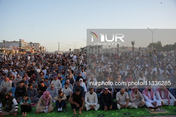 Muslims in Syria perform Eid al-Adha prayers in an open-air area in Bab al-Hawa Square, in the countryside of Idlib, northwest Syria, on the...