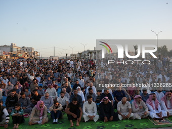 Muslims in Syria perform Eid al-Adha prayers in an open-air area in Bab al-Hawa Square, in the countryside of Idlib, northwest Syria, on the...