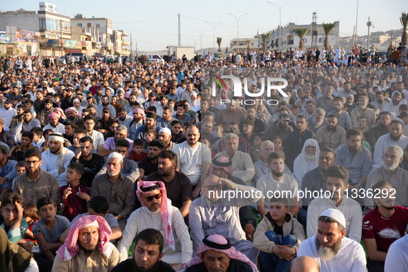 Muslims in Syria perform Eid al-Adha prayers in an open-air area in Bab al-Hawa Square, in the countryside of Idlib, northwest Syria, on the...