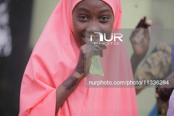 A Muslim faithful is taking yogurt with excitement as Muslim faithful are praying to mark the Eid-El-Kabir festival in Ikeja, Lagos, Nigeria...