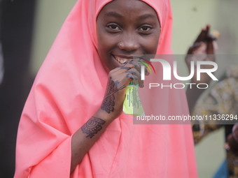 A Muslim faithful is taking yogurt with excitement as Muslim faithful are praying to mark the Eid-El-Kabir festival in Ikeja, Lagos, Nigeria...