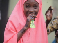 A Muslim faithful is taking yogurt with excitement as Muslim faithful are praying to mark the Eid-El-Kabir festival in Ikeja, Lagos, Nigeria...