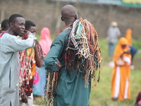 Prayer beads sellers are chatting as Muslim faithful are praying to mark the Eid-El-Kabir festival in Ikeja, Lagos, Nigeria, on Sunday, June...